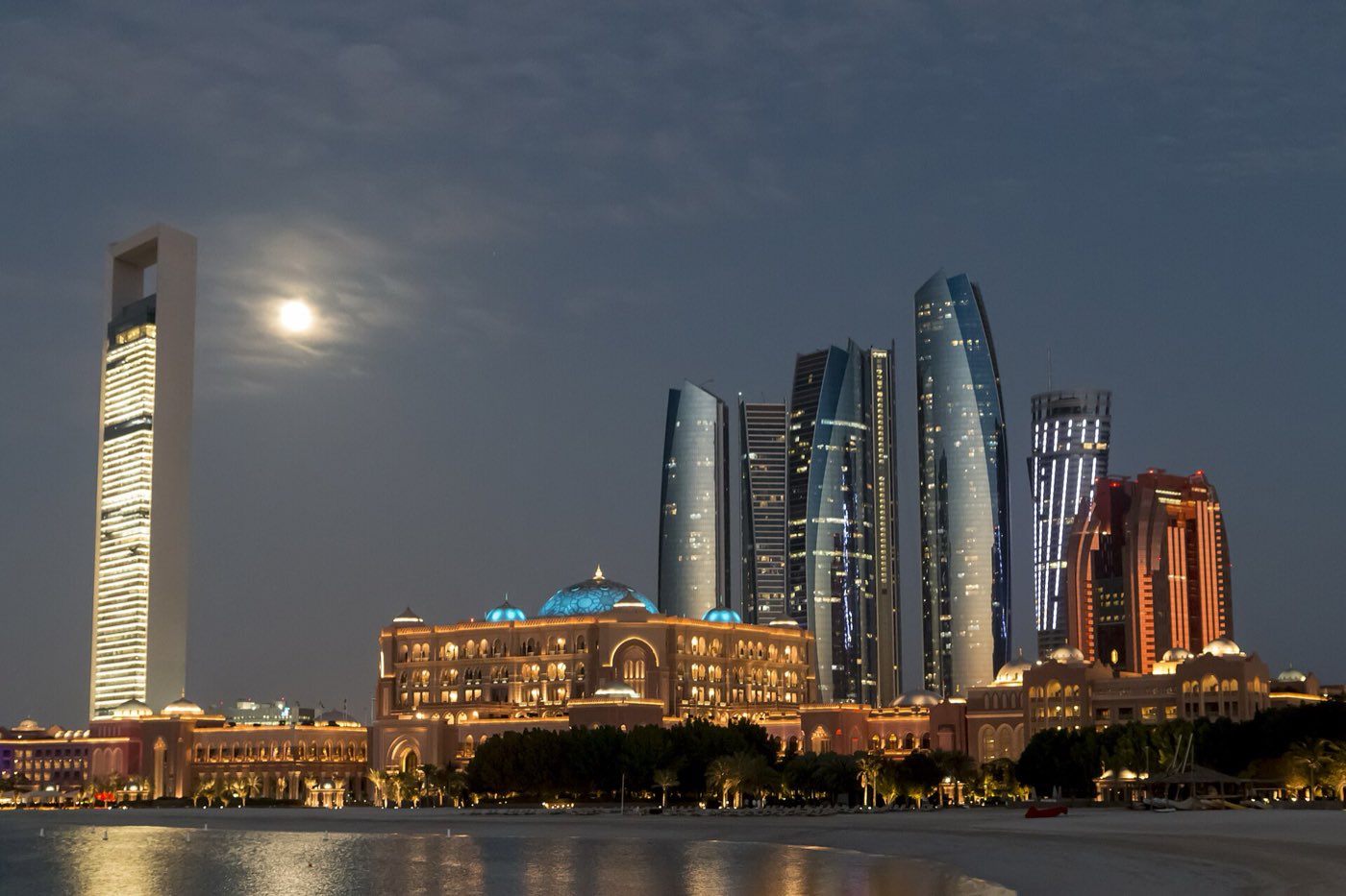 The Abu Dhabi skyline at night seen across the water.